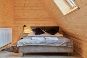 a bedroom with a bed in a wooden cabin at Domek Apartament u Wilków na wyłączność Zakopane in Zakopane