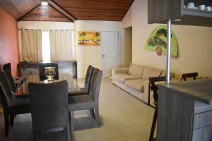 a living room with a table and a couch at Hibiscus Center in Búzios