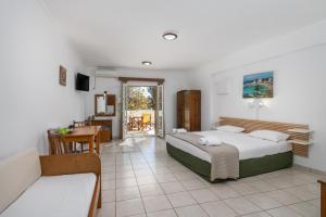 a bedroom with a bed and a table and a couch at Olive Studios in Adamantas