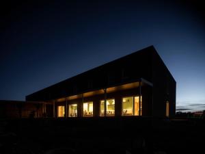 a large building with glass windows at night at Motel Waidhofen an der Thaya in Waidhofen an der Thaya