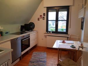 a small kitchen with a table and a window at Ferienwohnung Niederrhein in Wesel