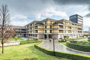 a building in front of a building at Broletto Park Apartment - Affitti Brevi Italia in Lecco