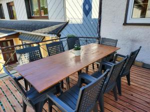 a wooden table and chairs on a deck at Das alte bauernhaus in Rohrbach