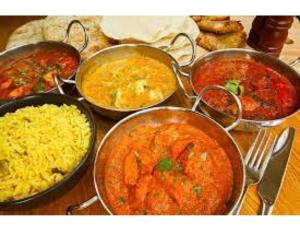 a table topped with pans of different types of food at Siddhi Vinayak Hotel & Marriage Garden, Chandukhedi in Ujjain