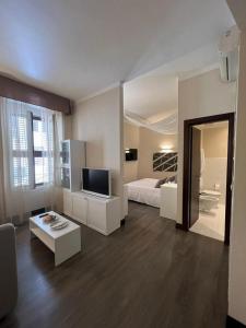 a large room with a bed and a television at Relais Piazza Del Popolo in Rome