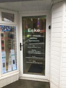 a store front door with a sign on it at Eske Holiday Apartment in Donegal