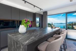 a kitchen with a counter with a vase of flowers on it at "Villa AnMari" The Cavtat View Residence in Cavtat