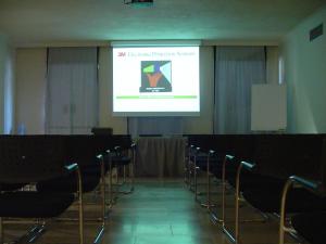 a lecture room with a projector screen and chairs at Villa Martini in Castiglioncello +66 photos