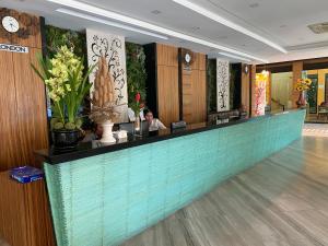 a woman sitting at a counter in a hotel lobby at Le Vernissage by Goad Avadhess Hospitality in Pattaya Central +127 photos
