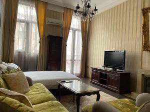 a living room with a couch and a flat screen tv at Tsar Simeon Veliki in Stara Zagora