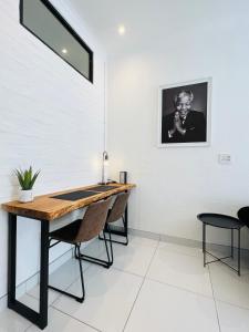 a dining room with a table and two chairs at Industrial CHIC Apartment 113 - Luxury City Escape, Washing Machine & Fast WiFi in Johannesburg