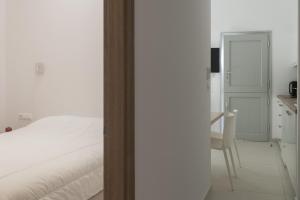 パリキアにあるParikia's Cosy Jewelのベッドとテーブルと椅子のある寝室