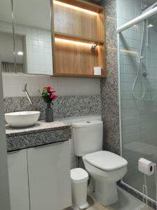 a bathroom with a toilet and a sink at Rio Park Ave, Sea View One - By TRH Invest in Recife
