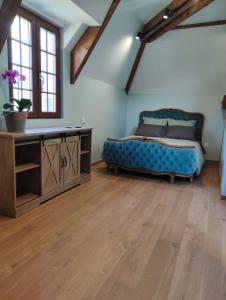 a bedroom with a bed and a wooden floor at Entre Galets in Sauveterre