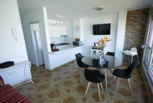 salon ze stołem i krzesłami oraz kuchnia w obiekcie Frontline Penthouse - Prixmar - by VV Canary Ocean Homes w mieście El Pris +11 zdjęć