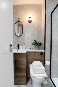 a bathroom with a toilet and a sink at St George's Residence in Glasgow