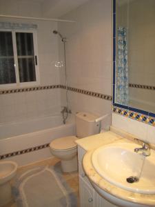 a bathroom with a toilet and a sink and a tub at Casa Yvonne in Rojales +26 photos