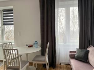 a living room with a table and a couch at Apartament rodzinny 40m2 in Pabianice +4 photos