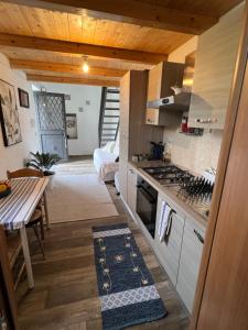 a kitchen with a table and a stove top oven at BellaLimone in Calatabiano