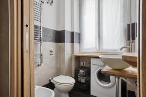 a bathroom with a toilet sink and a washing machine at C Studio - Design Bilo Suite -M3- 8 min dal Duomo in Milan +31 photos
