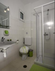 a bathroom with a toilet and a shower and a sink at Kalathos Sun Hotel in Kalathos