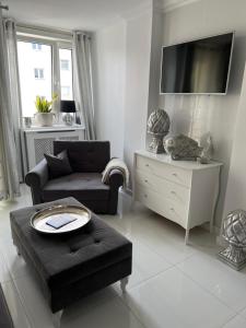 a living room with a couch and a table at Apartament Chanel Centrum in Malbork