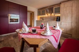 a kitchen with a table with a red table cloth at Beautiful holiday home in a stunning location with sauna in Fügen