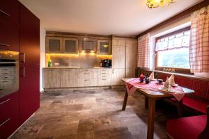 a kitchen with a wooden table and a window at Beautiful holiday home in a stunning location with sauna in Fügen