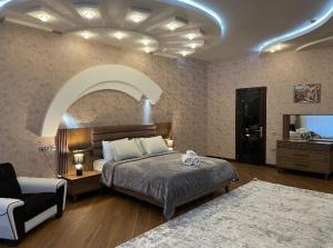 a bedroom with a bed and a couch and a room with at Grand Sea View Megafun in Baku