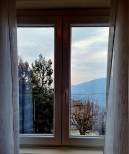 a window with a view of a mountain view at MUN Apartment - Major Unforgettable Nights in Fuipiano Valle Imagna