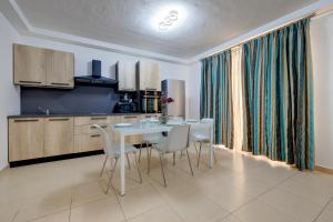 a kitchen with a table and chairs in a room at Sliema Tigne Suites in Sliema