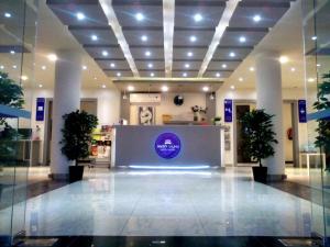 a lobby with a counter in the middle of a building at Rofan Hotel Suites in Riyadh