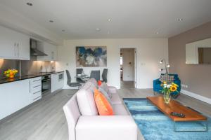 a living room with a white couch and a table at IFSC Townhouse Apartments in Dublin