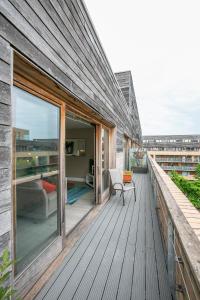 a wooden deck with a couch and a chair on a building at IFSC Townhouse Apartments in Dublin