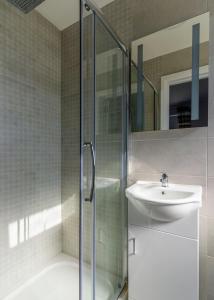 a bathroom with a glass shower and a sink at Sand Dunes Room 3 in Waterford