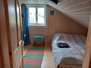 a small bedroom with a bed and a window at Chata Adam je pre rodiny s deťmi terasa, detské ihrisko in Liptovský Mikuláš