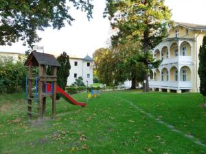a playground in the yard of a house at Villa Granitz - Ferienwohnung Kettelhoit in Göhren
