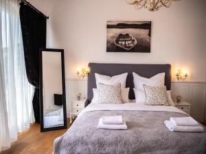 a bedroom with a large bed and a mirror at Elegant Hvar town villa with pool in Hvar