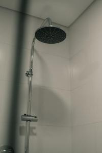 a shower with a shower head in a bathroom at Apartamento Mar & Bor - RRAL nº3126 in Praia da Vitória