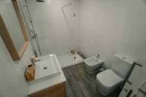 a bathroom with a sink and a toilet and a shower at Apartamento Mar & Bor - RRAL nº3126 in Praia da Vitória +11 photos