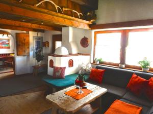 a living room with a couch and a table at Ferienhaus Alpina Ötztal in Sautens