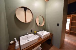 two sinks in a bathroom with two mirrors at Dive INN Kiryu in Kiryu