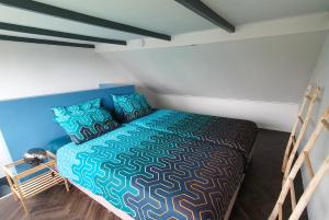 a bedroom with a bed and two bunk beds at De Fluessen Loft in Elahuizen