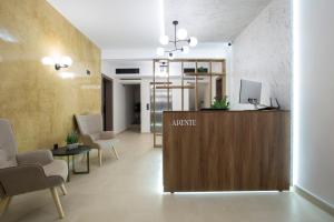 a lobby with a reception desk and chairs at Arente Apartments in Lefkada Town