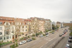 a view of a city street with cars parked at Stylish apartment with free BaselCard in Basel