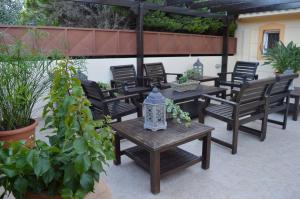 a group of tables and chairs on a patio at VILLA AVATOS - Near to the port of Rafina and the airport of Athens in Áyios Spirídhon