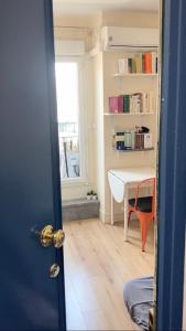 a room with a desk and a table and a door at Studio Quartier Latin in Paris