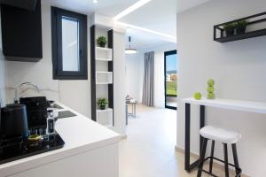 a white kitchen with a stove and a counter top at Arente Apartments in Lefkada Town