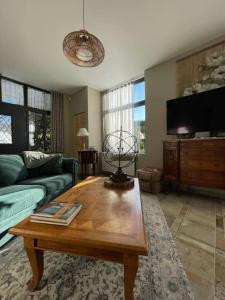 a living room with a couch and a coffee table at Le pigeonnier / Gîte de charme 1 à 4 pers 80 m² in Cambrai