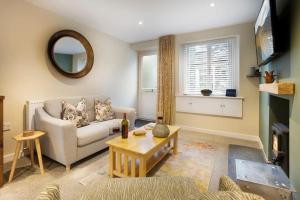 a living room with a couch and a table at Garn Yam Cottage in Ambleside